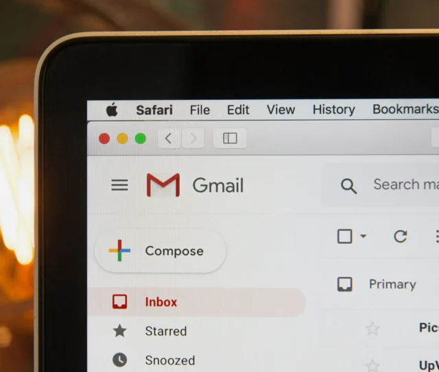 A close up of a laptop screen showing the Gmail inbox and the Safari browser menu bar at the top. The Compose button and inbox categories are visible, highlighting how UK business professionals might manage email records efficiently ahead of 2026.