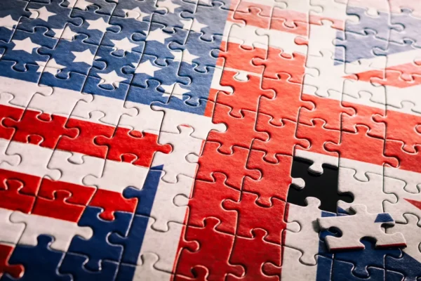 A jigsaw puzzle combining the flags of the united states and the united kingdom, with one piece missing near the lower right corner, symbolizes the evolving uk ai landscape and growing us tech investment.