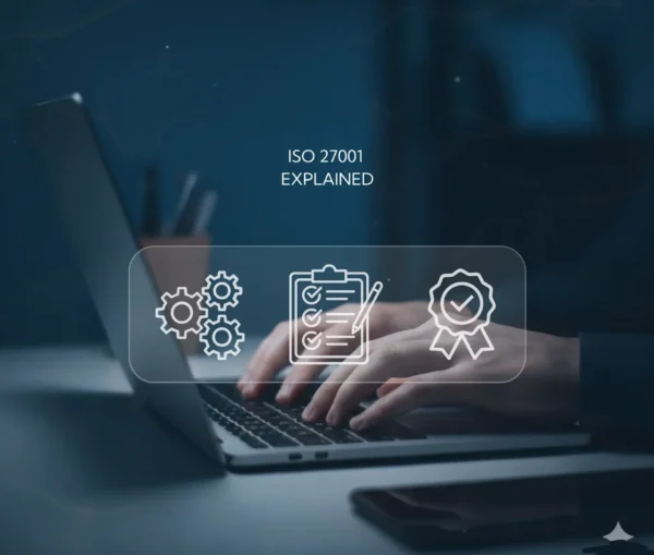 Person typing on a laptop with overlay icons of gears, a checklist, and a ribbon. text reads "iso 27001 explained," highlighting how information security standards benefit smes.