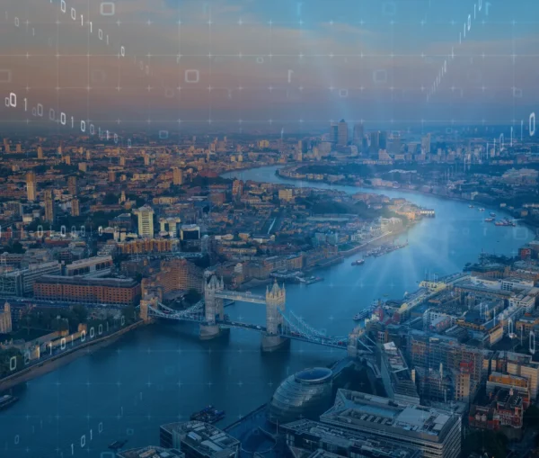 Aerial view of central london featuring tower bridge over the thames, overlaid with digital graphics—including binary code and geometric shapes—highlighting ai for uk businesses and innovative technology trends.