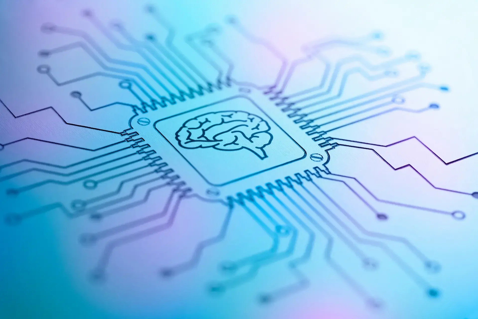 Close up of a computer chip with a brain symbol in the center, surrounded by circuit lines representing custom ai development and its strategic benefits for business technology.