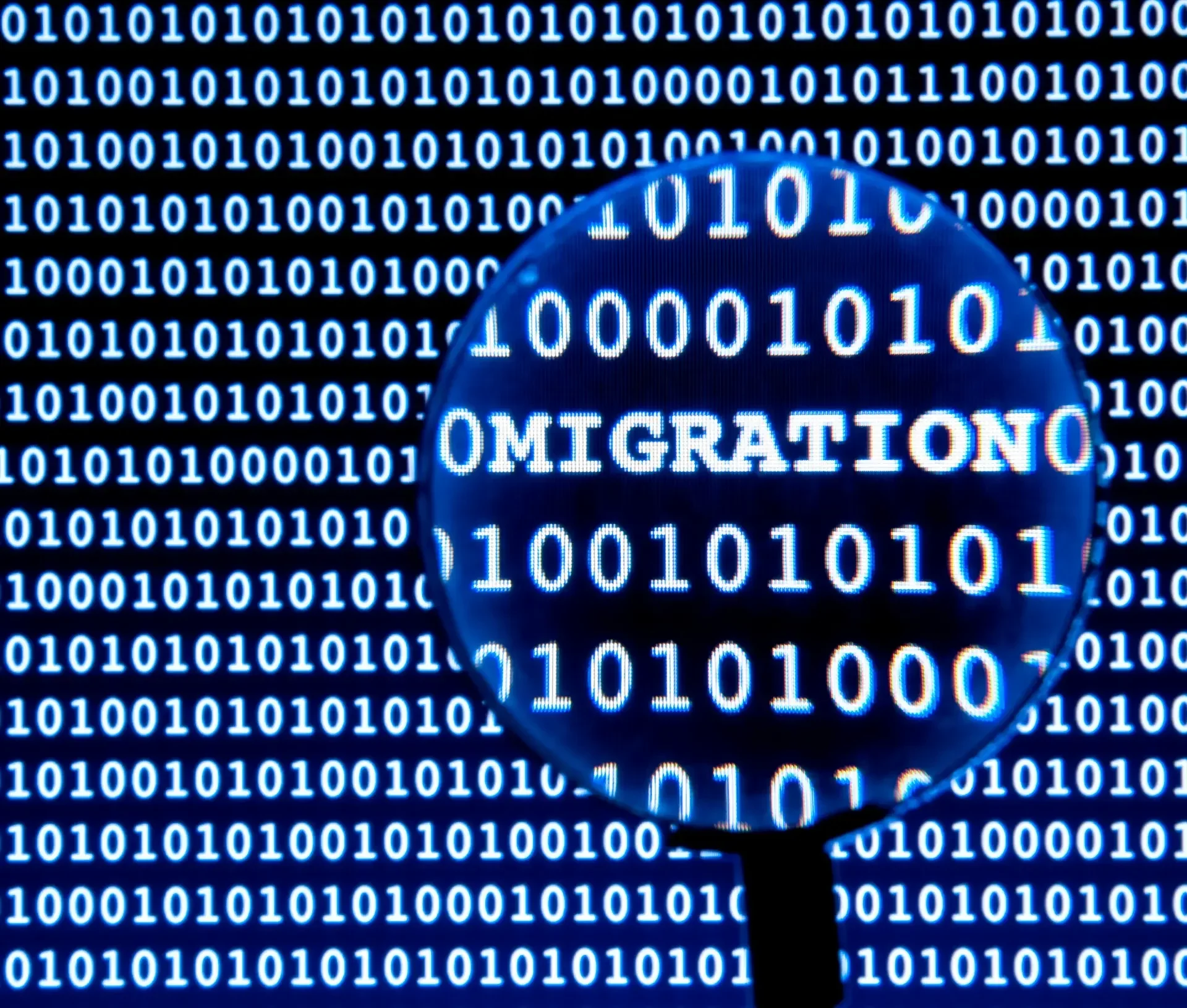 A magnifying glass highlights the word "migration" among binary code (ones and zeros) on a digital screen, symbolizing seamless cloud migration and business continuity.