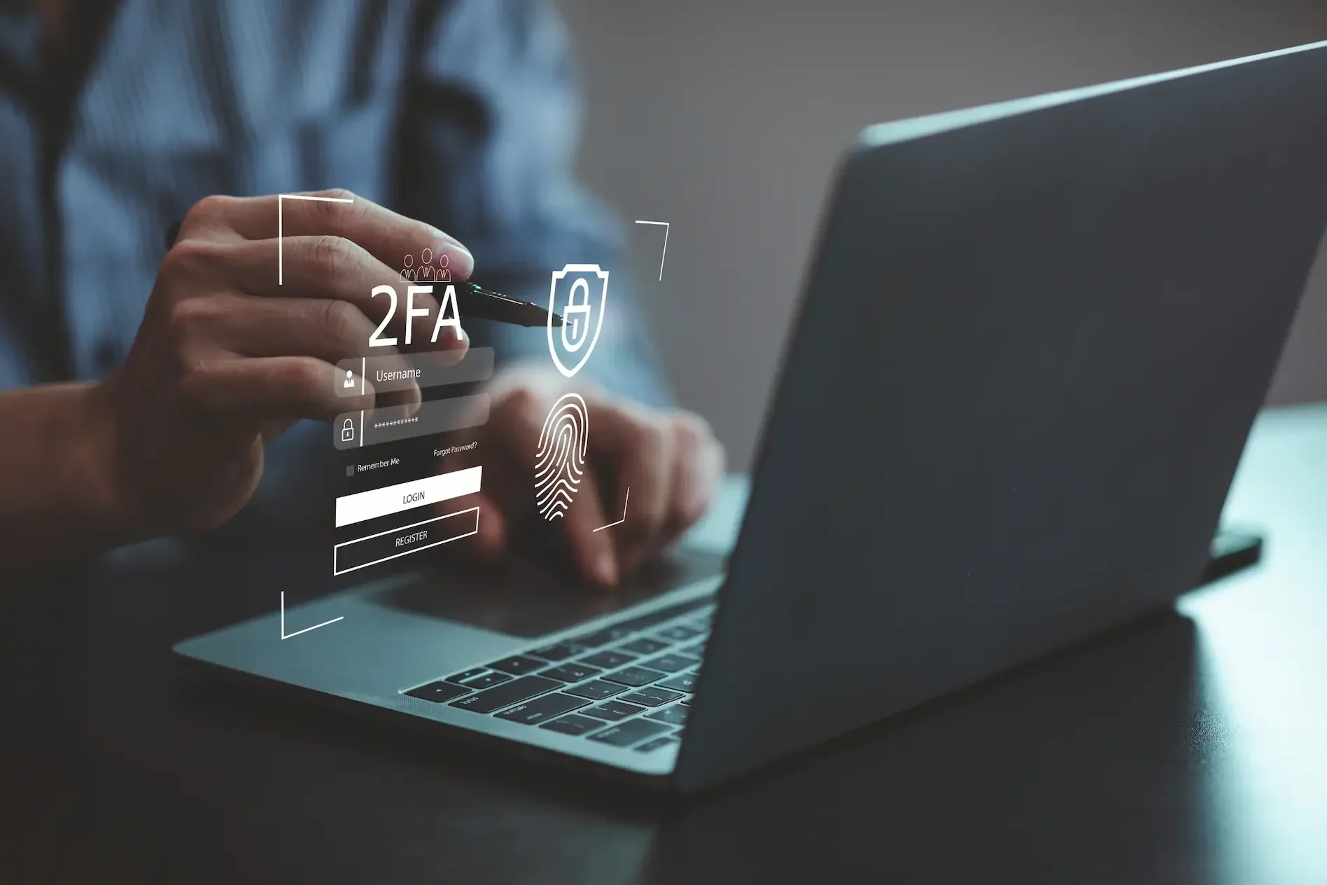 Person using a laptop with digital icons for mfa, fingerprint, password, and security shield displayed, highlighting advanced cybersecurity measures and multi factor authentication.