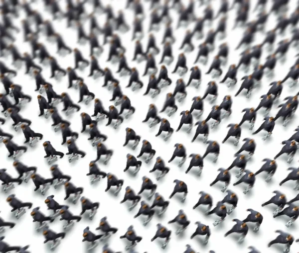 A large group of emperor penguins standing closely together, viewed from above on a white background, evokes the unity and indistinguishability seen in deepfakes or ai impersonation, where real and artificial identities blend seamlessly.