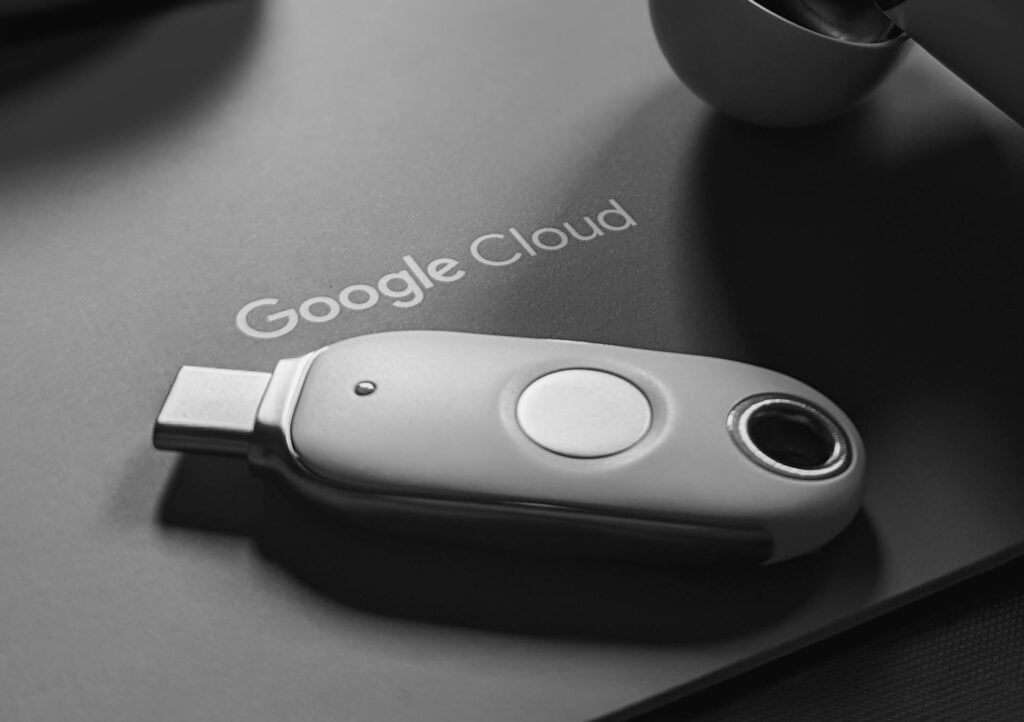 Black and white tech scene featuring a USB device and Google Cloud logo, embodying digital connectivity.