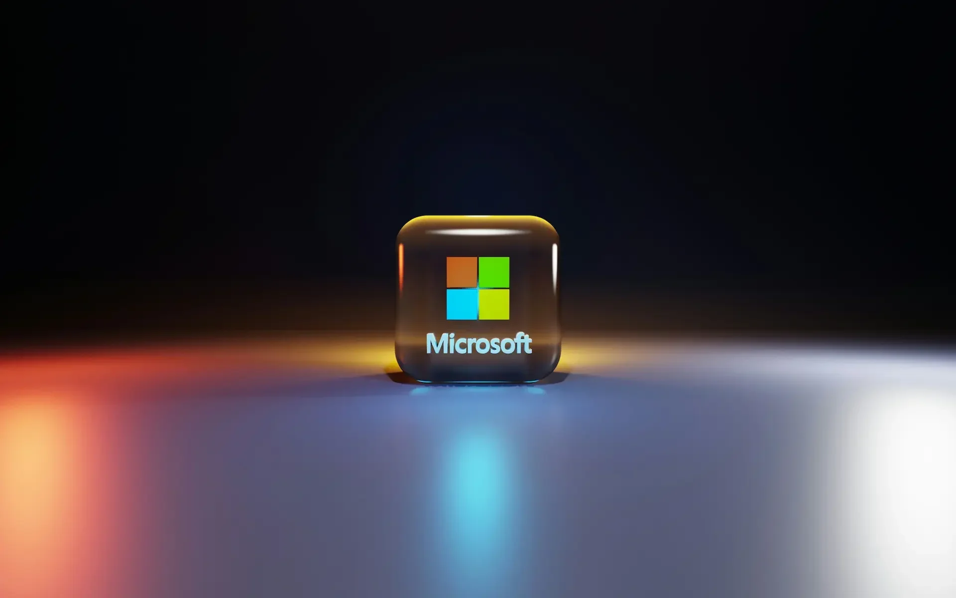 A 3d rendered microsoft logo cube sits on a reflective surface, illuminated by blue, red, and yellow lights, with a dark background—evoking the era of windows 10 and its extended security updates.