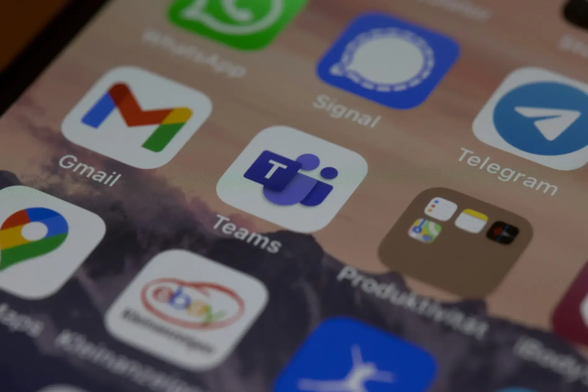 A smartphone screen displays app icons including gmail, chrome, ebay, signal, telegram, and microsoft teams, highlighting everyday productivity apps ahead of the classic teams retirement in july 2025.
