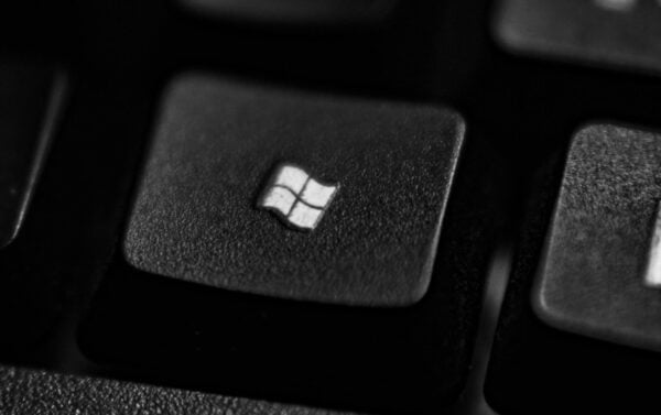 High-quality close-up of a Windows logo key on a black plastic keyboard.