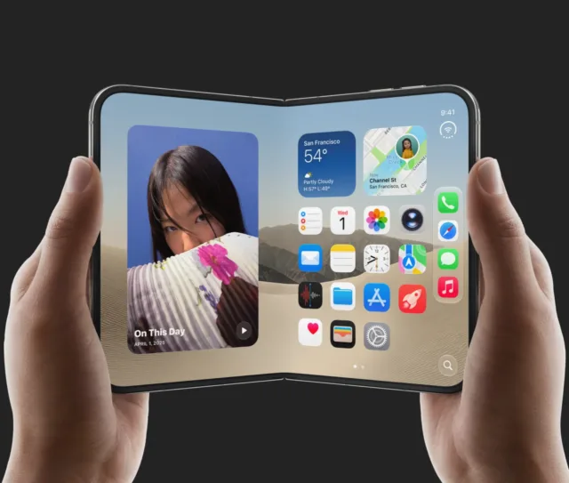 A person holds a foldable smartphone open, displaying a home screen with various app icons and widgets on both halves of the flexible screen. The background is a desert scene—rumoured to be the new iPhone Duo available for pre orders.