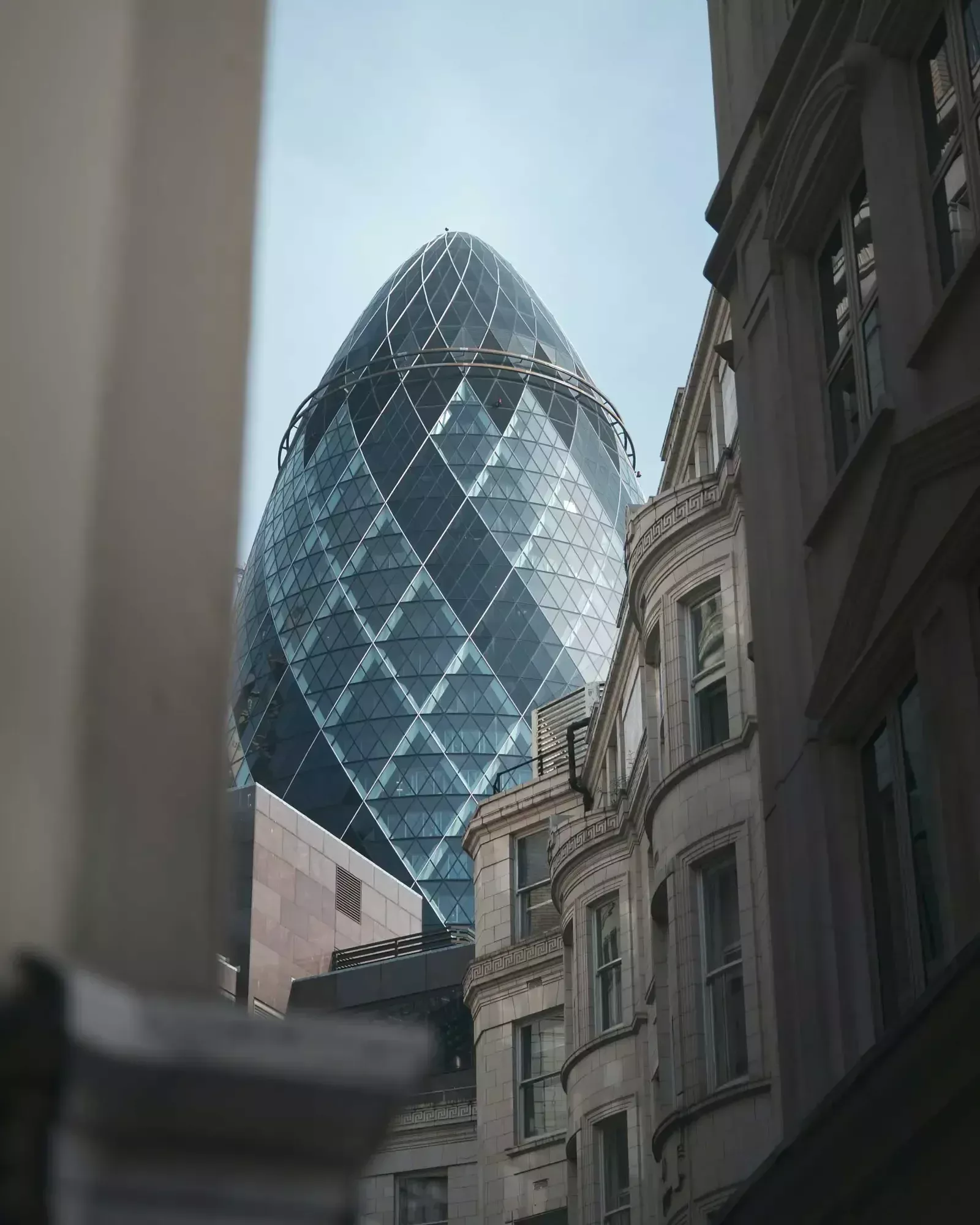 A photo of The Gherkin appearing between other buildings